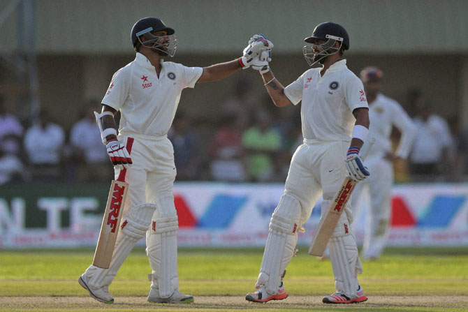 श्रीलंकेविरुद्धच्या पहिल्या कसोटीत सलामीवीर शिखर धवन आणि कर्णधार विराट कोहलीने अर्धशतक गाठले आहेत. (पीटीआय)
