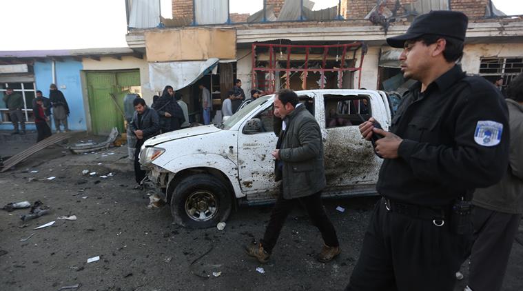 Afghan security forces inspect the site of a suicide car bomb attack near the Kabul airport in Kabul, Afghanistan, Monday, Dec. 28, 2015. No group has claimed responsibility for the early-morning attack. (AP Photo/Rahmat Gul)