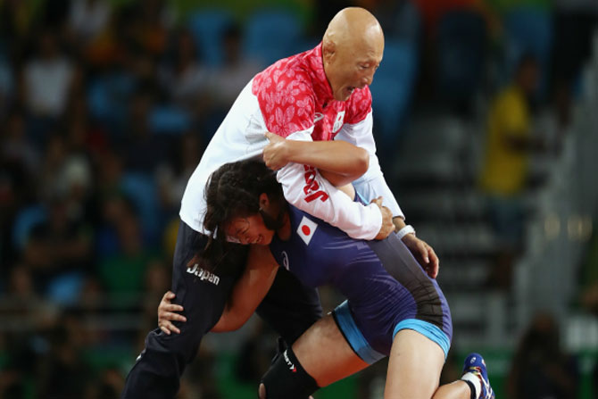 Japanese wrestler celebrates gold by slamming her middle aged coach , japan medal tally , amazing videos,