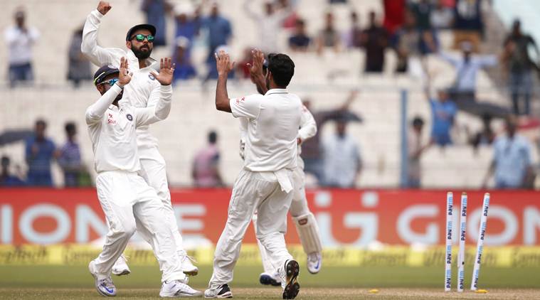 Indian cricketers celebrate the fall of New Zealand's batsman Martin Guptill, on the second day of the second cricket test match, in Kolkata, India, Saturday, Oct. 1, 2016. (AP Photo/Saurabh Das)