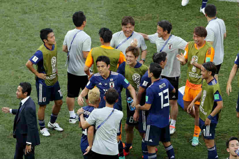पराभवाचे दुःख, पण बाद फेरीत प्रवेश केल्याचा आनंद साजरा करताना जपानचे खेळाडू 
