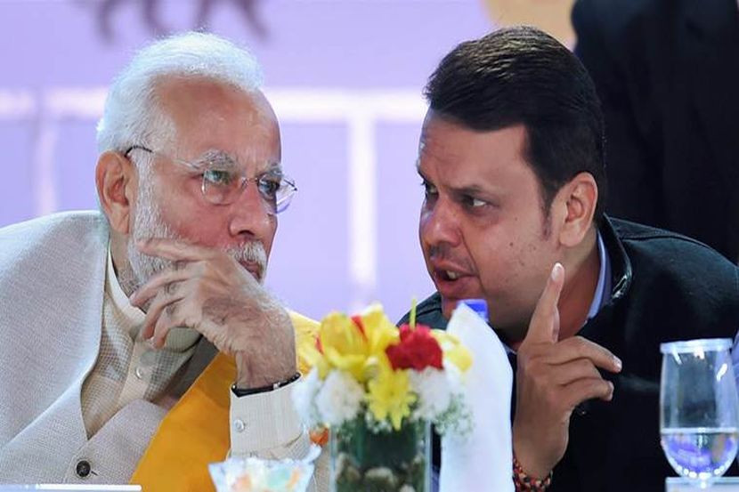 Mumbai: Prime minister Narendra Modi talks with Maharashtra CM Devendra Fadnavis during the opening ceremony of the Magnetic Maharashtra Convergence 2018 in Mumbai on Sunday. PTI Photo by Shashank Parade(PTI2_18_2018_000261A)