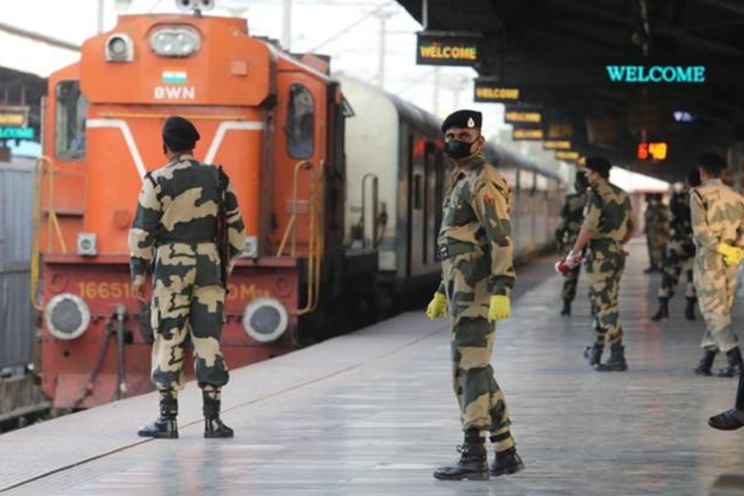CRPF personnel wear masks while on duty at a railway station in Kolkata. (Express photo: Partha Paul)