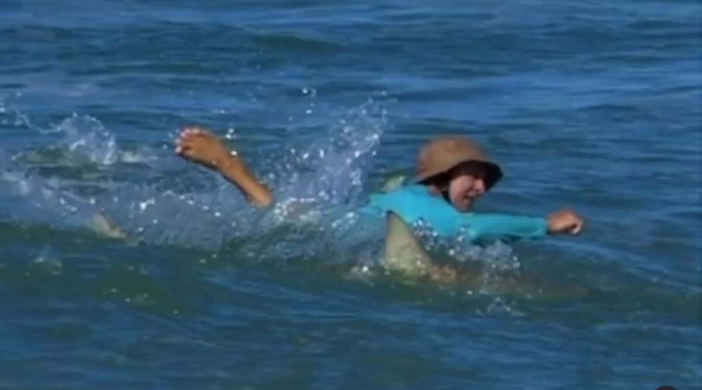 sharks-surround-man-surfing-on-florida-beach