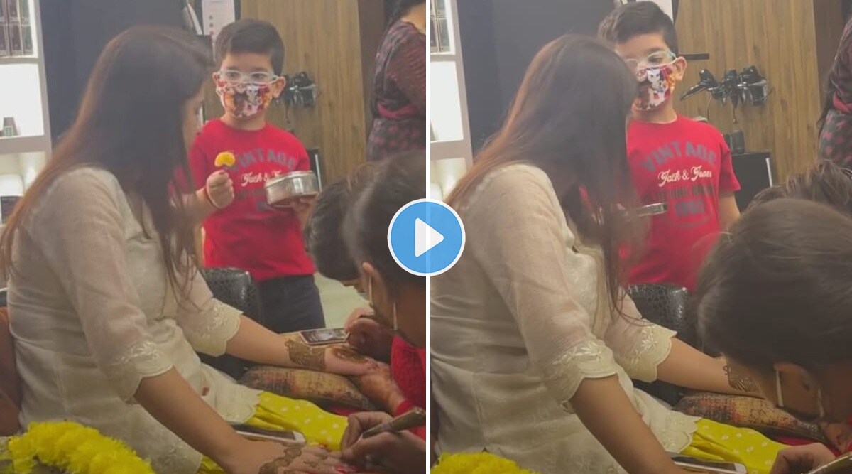 Little boy feeds mom