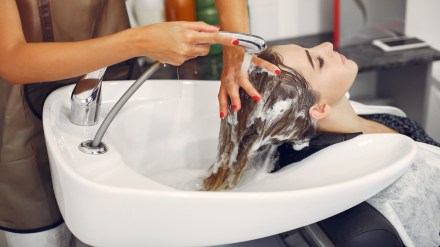 Woman washing head in a hairsalon