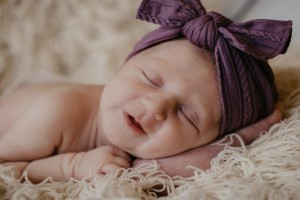 baby smiling while sleeping unsplash