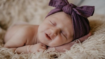 baby smiling while sleeping unsplash