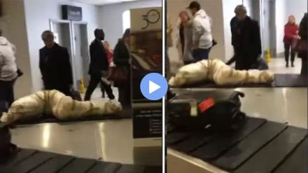 A corpse wrapped in paper on an airport conveyor belt