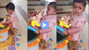 A little baby is opposing to Ganesha immersion