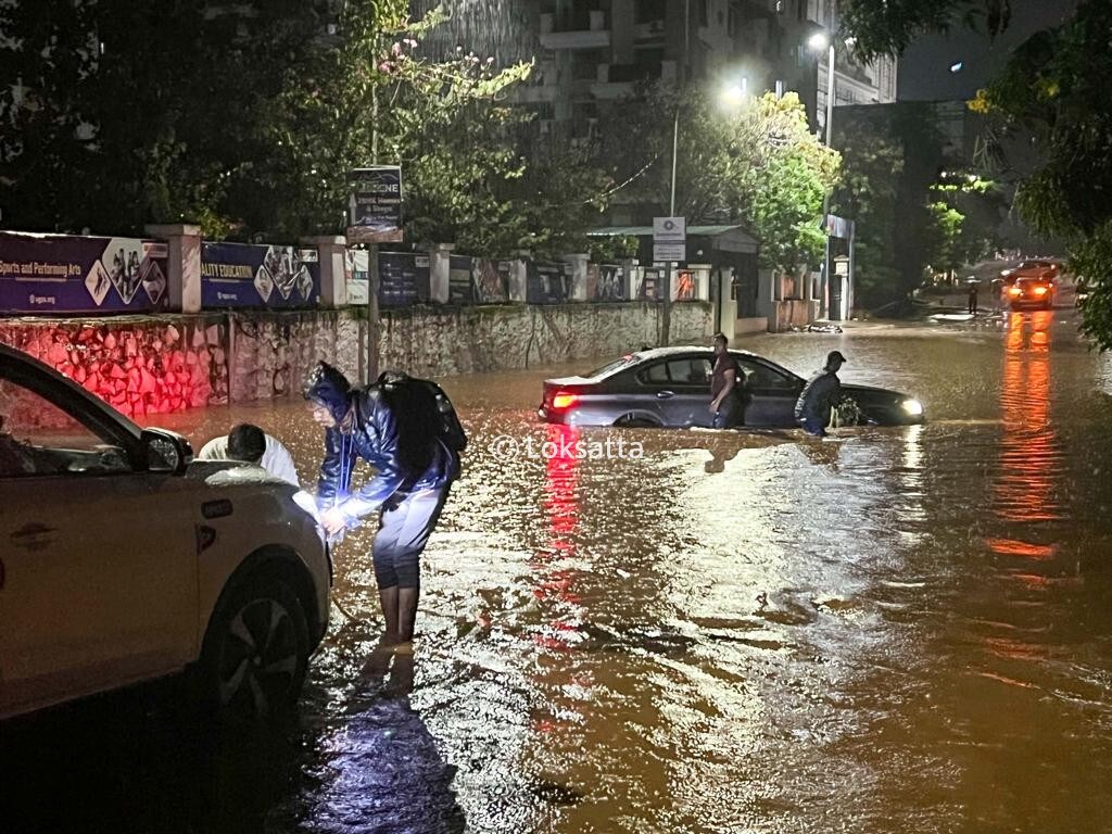 Pune Rain Photos A BMW 5 series car held on a submerged road near Vibgyor school at NIBM annex