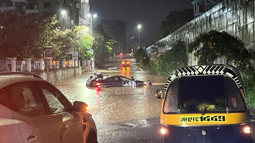 Pune Rain Photos A BMW 5 series car held on a submerged road near Vibgyor school at NIBM annex