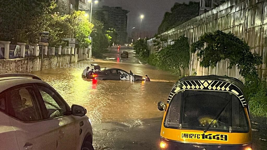 Pune Rain Photos A BMW 5 series car held on a submerged road near Vibgyor school at NIBM annex