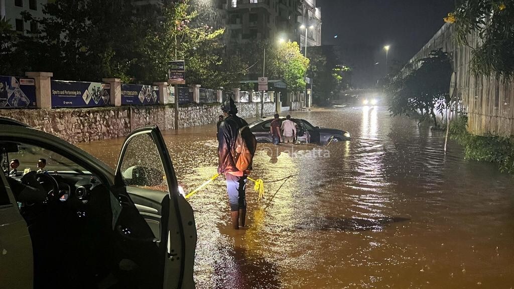 Pune Rain Photos A BMW 5 series car held on a submerged road near Vibgyor school at NIBM annex