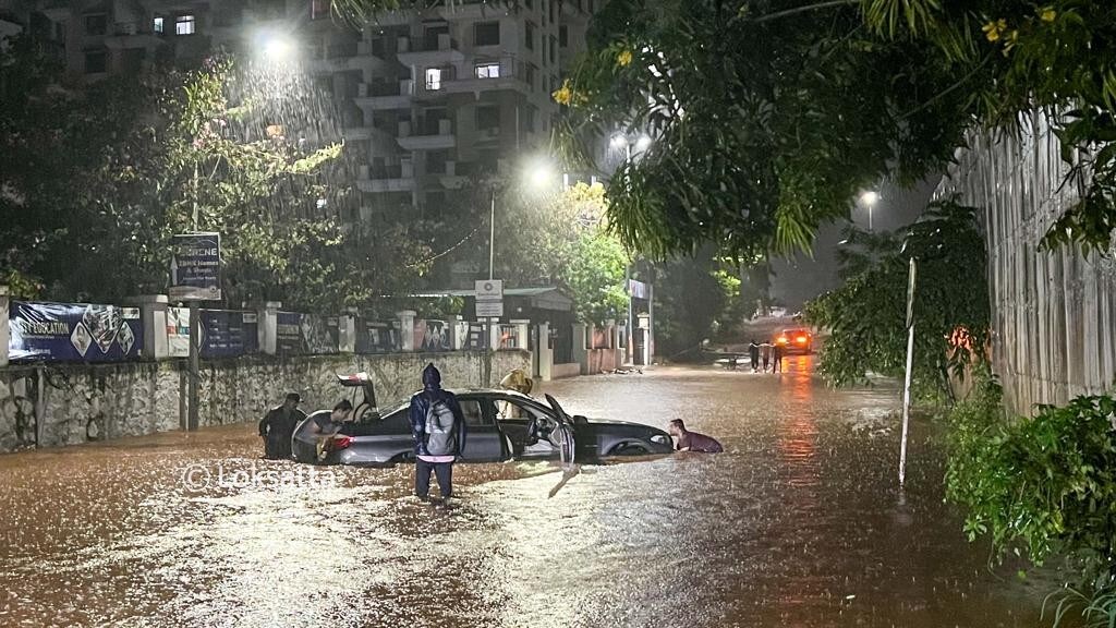 Pune Rain Photos A BMW 5 series car held on a submerged road near Vibgyor school at NIBM annex