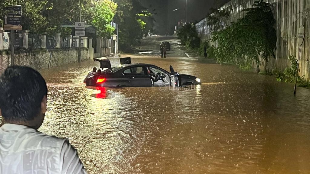 Pune Rain Photos A BMW 5 series car held on a submerged road near Vibgyor school at NIBM annex