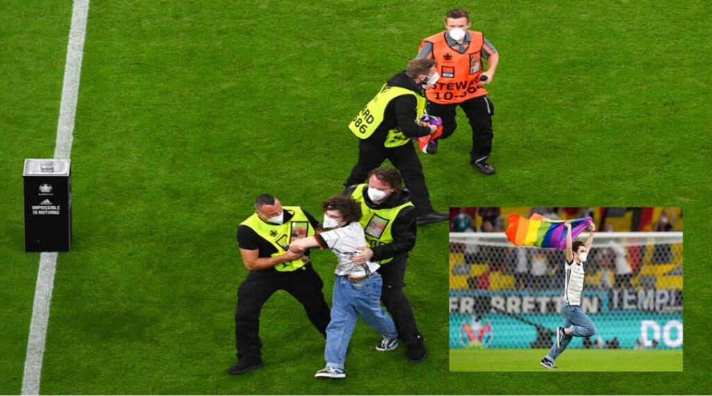 fan carrying LGBTQ flag enters the ground