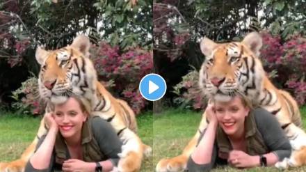 woman gave pose with tiger for photoshoot