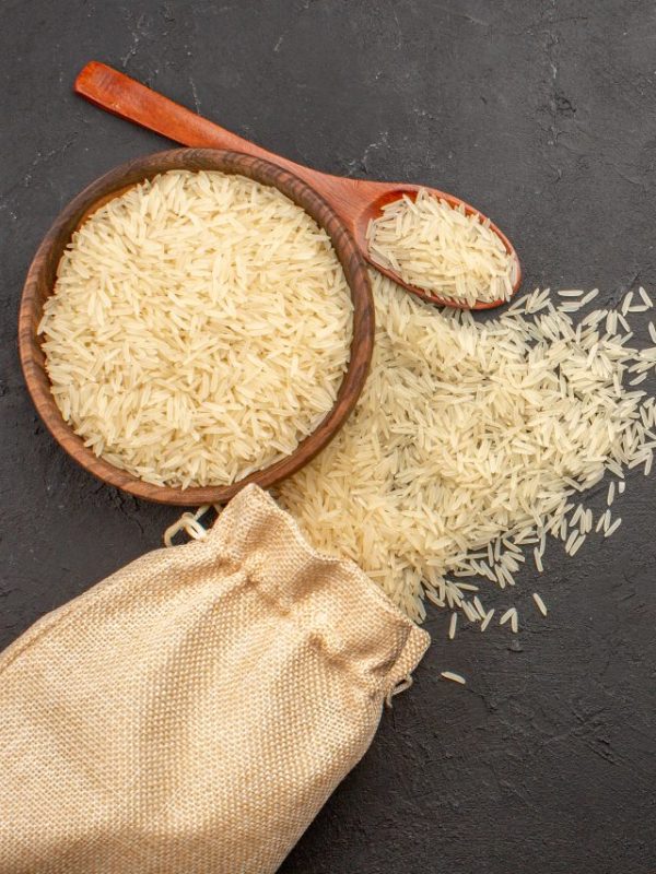 top-view-raw-rice-inside-brown-plate-grey-surface