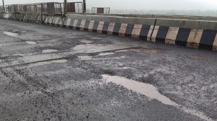 Potholes on the newly constructed concrete road by CIDCO