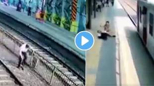 A person uses a railway track to reach another platform and in the process his slipper falls off