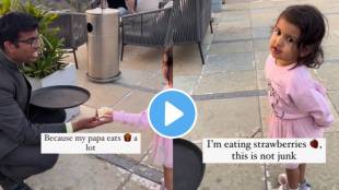 A toddler stops her dad from eating fries and returns the french fries to the waiter
