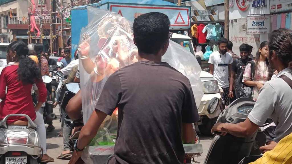 devotees carrying ganesha idols on two wheelers affected by the traffic jam in uran city