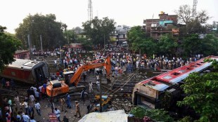 Rescuers and other gather around coaches of the North-East Express passenger train that derailed late Wednesday near Raghunathpur railroad station in Buxar district of Bihar