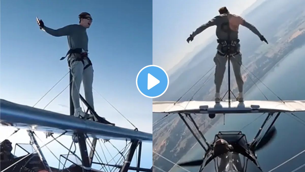 Man doing stunt on a top of Moving plane