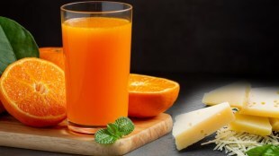 Man drinks orange juice with slice of cheese