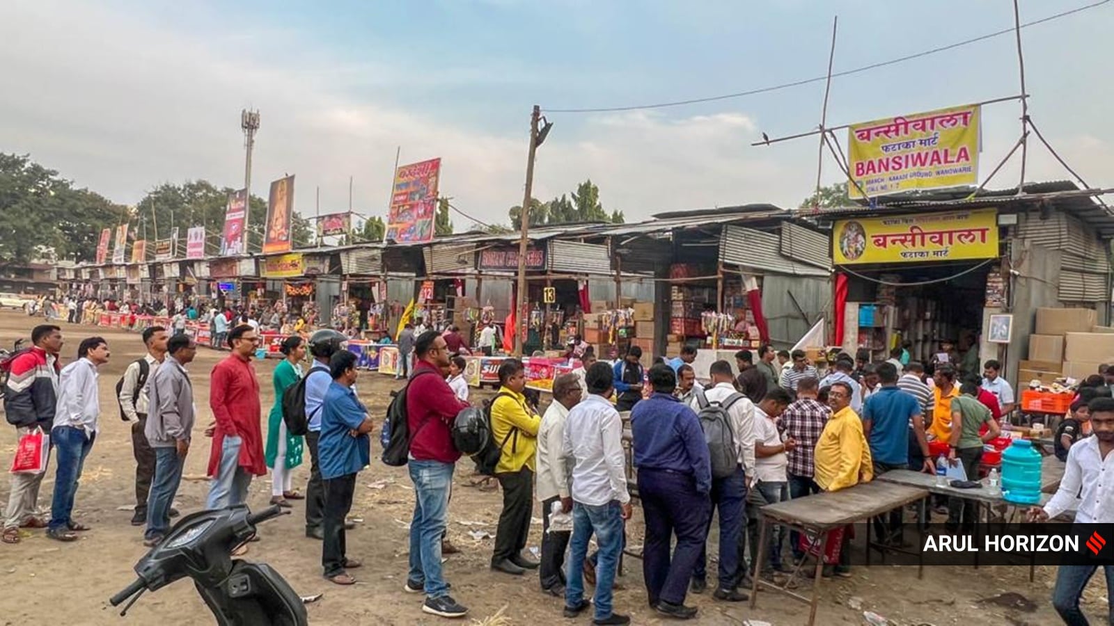 People in queue at the cracker stalls at Golibar Maidan in Pune as the Diwali approaches. (Express Photo by Arul Horizon)