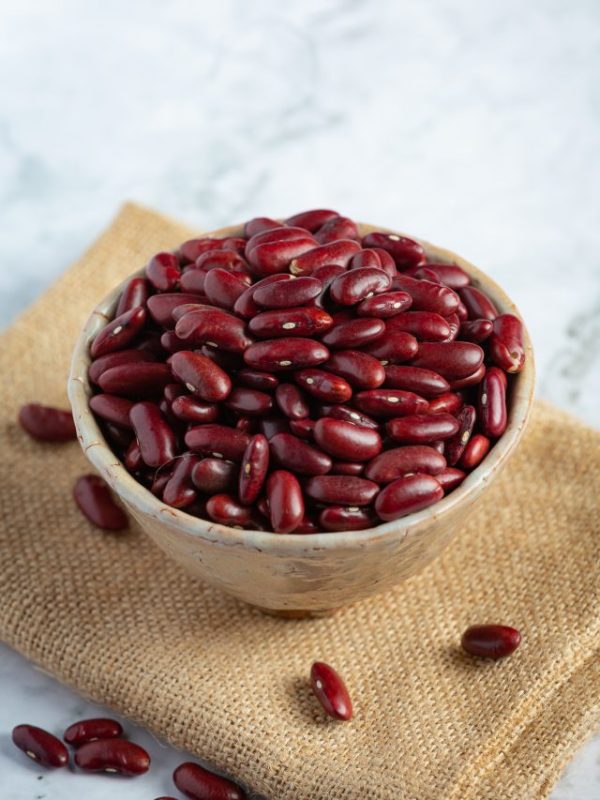 Red kidney beans in a small bowl place on sack fabric
