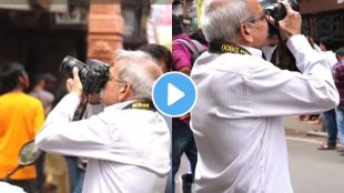 a old man keeping his hobby of photography