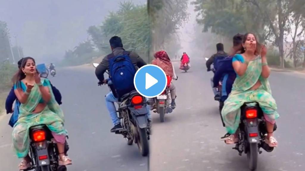 Girl gives flying kiss sitting upside down on bike