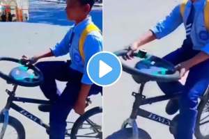 boy desi jugaad of placing car steering as cycles handle video goes viral on social media