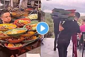 Waiter carries more than a dozen plates at once over his one hand