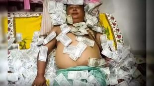 Benjamin Basumatary sleeping on cash