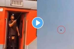 a man flying a kite while standing at the train gate video goes viral on social media