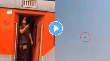 a man flying a kite while standing at the train gate video goes viral on social media