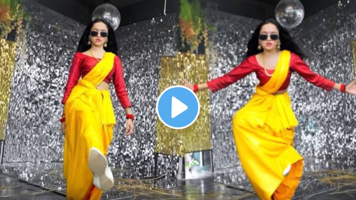 A young woman wearing a sari dances to the song Pushpa Pushpa