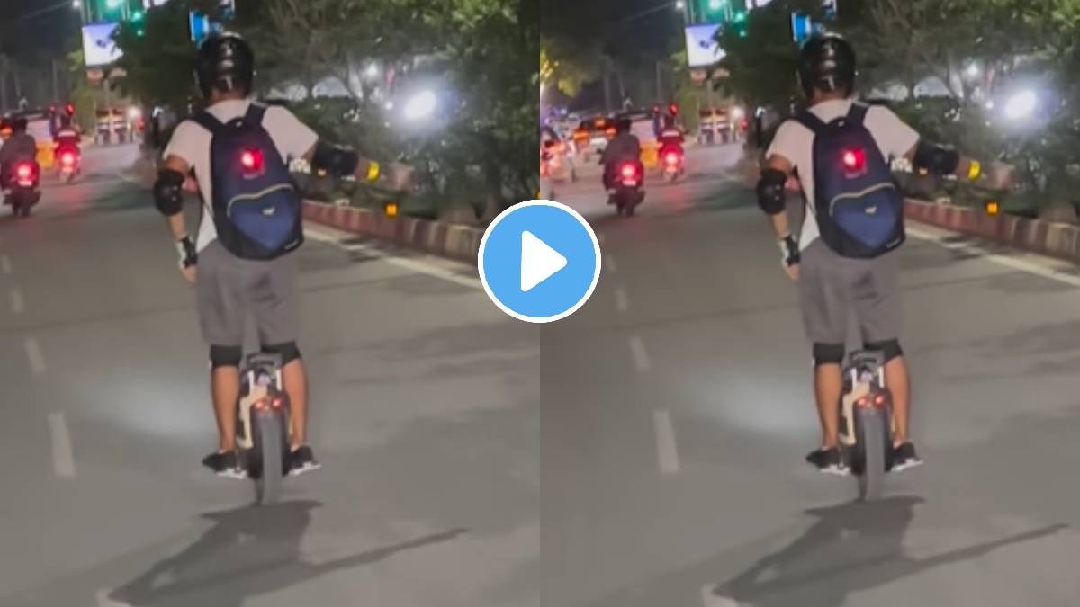 Man Riding Unicycle and balancing a cycle bearing just one wheel on the roads of India people caught the incident on camera