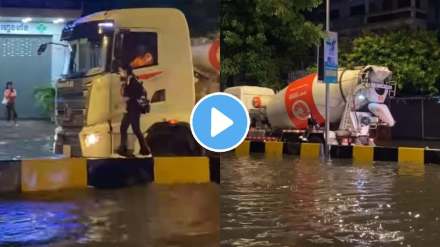 truck driver helps young girl cross waterlogged street during heavy rainfall