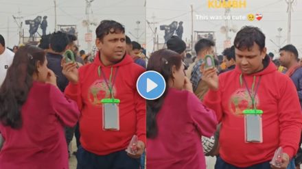 e a man holding mirror for a wife while doing makeup in mahakumbh mela