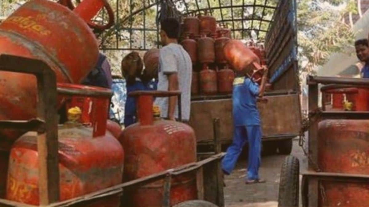 Delivery workers handling 19-kg LPG cylinders in New Delhi after the recent price cut.