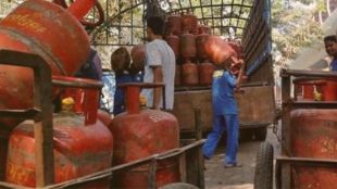 Delivery workers handling 19-kg LPG cylinders in New Delhi after the recent price cut.
