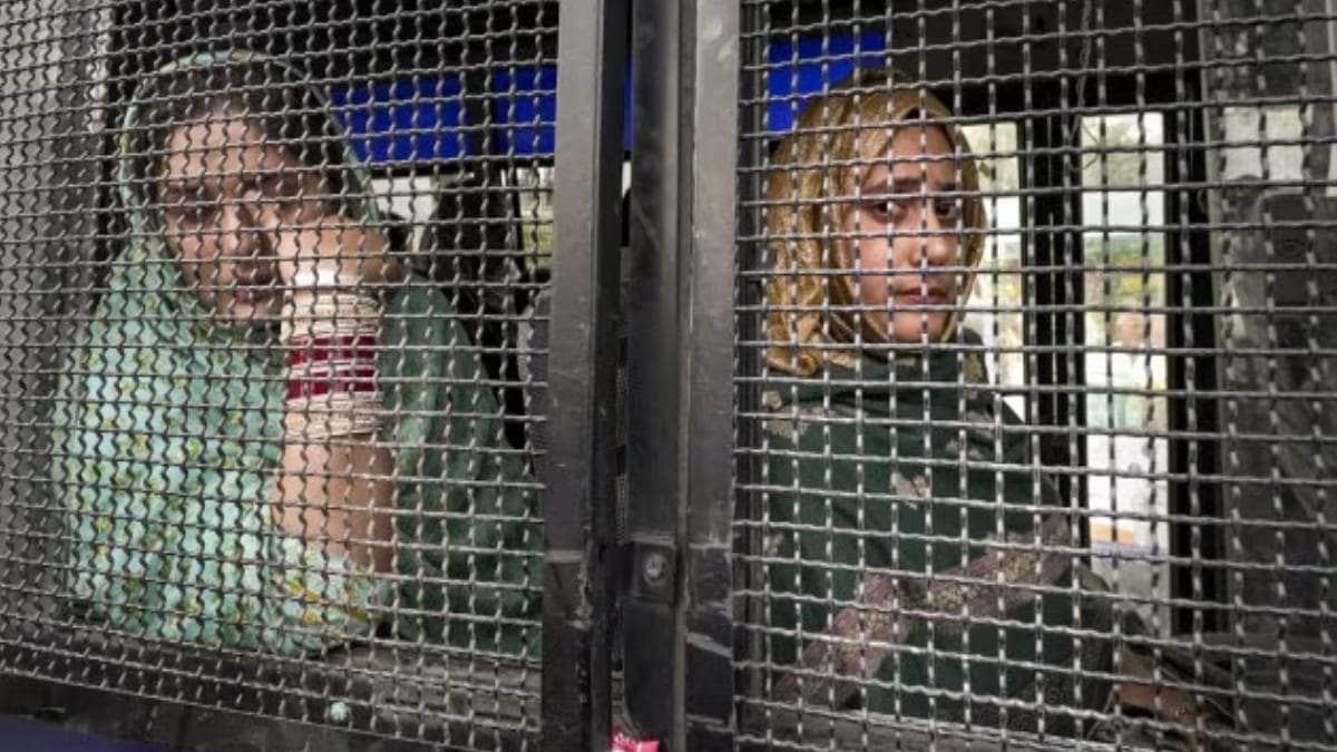 Minal and Ayesha, Pakistani nationals married in India, are brought to the Attari border by the Jammu and Kashmir Police on Tuesday. (PTI)