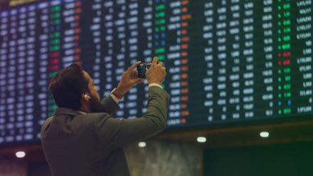 Stock traders monitor Sensex and Nifty as markets open with sharp gains