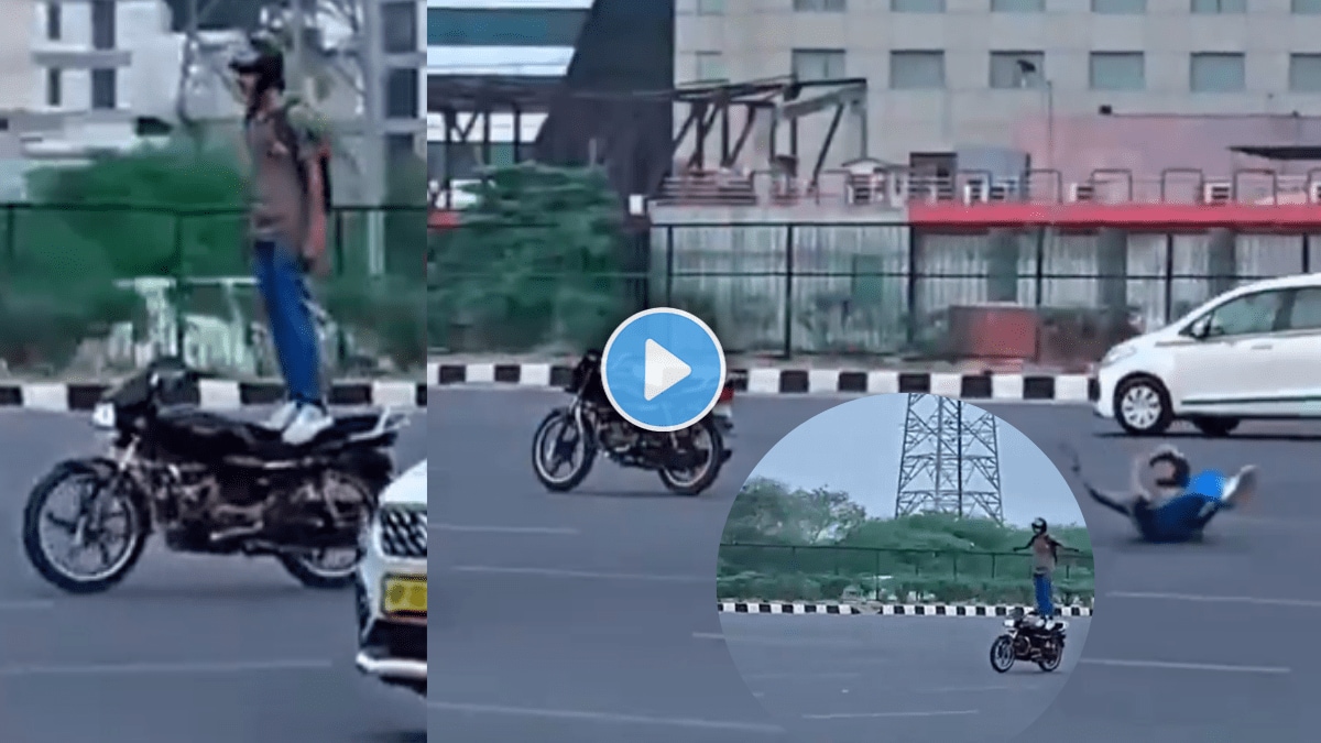 Stuntman standing on bike in busy road falls down in next moment