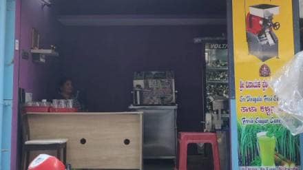 woman helps local sugarcane vendor