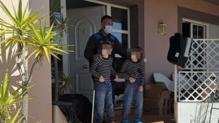 Child rescue officials at a rundown house after freeing children locked inside